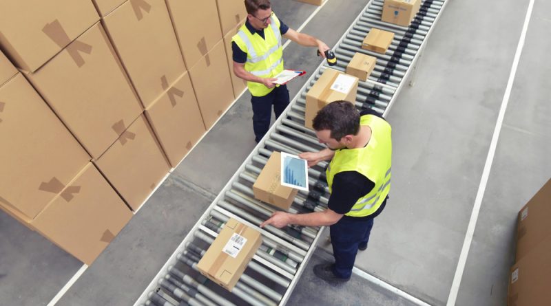 Two people working in warehouse checking stock