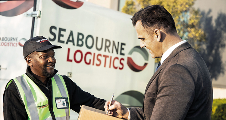 Smiling Seabourne staff member delivering package