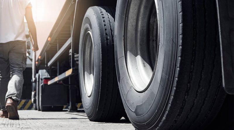 Close up image of the wheels of a large truck on the road to support Meadow Lark Transport closed article