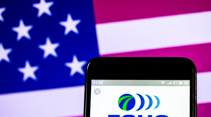 Image of the Echo Global Logistic logo on a phone screen in front of the American flag to support Top Workplaces USA 2024 article