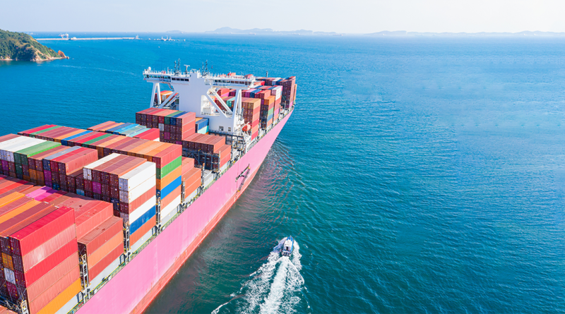 Image of a large cargo ship leaving a port into the ocean to support port infrastructure article