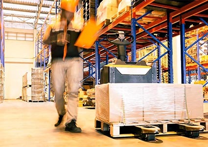 Motion blur of worker working in interior warehouse, warehouse inventory management
