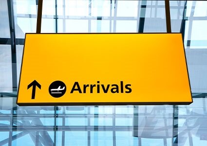 Yellow Arrivals sign at an airport