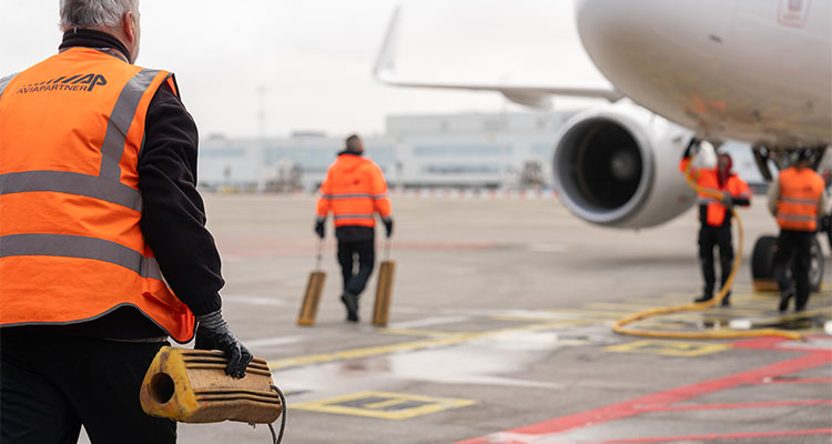 Airport ground crew servicing plane