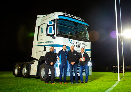 Multimodal truck on a rugby pitch at night