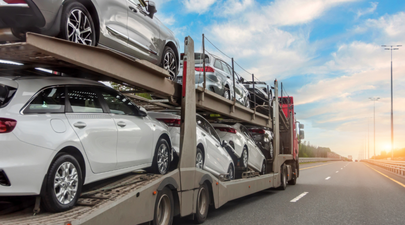 Car shipping in progress with vehicles loaded onto a transport truck.