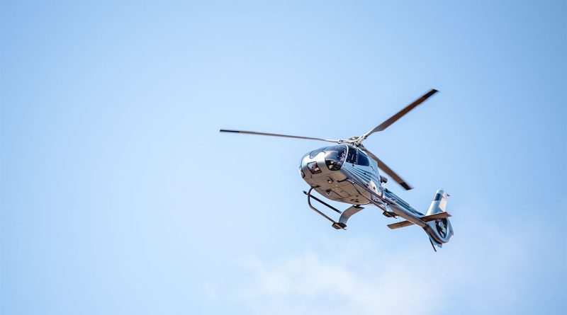 The Robinson orange, white and black R88 Helicopter