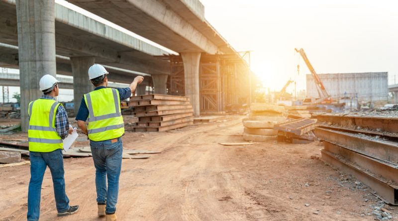 USDOT awards $488 M in BUILD grants to 30 vital infrastructure projects Bridge under construction with two engineers planning on road