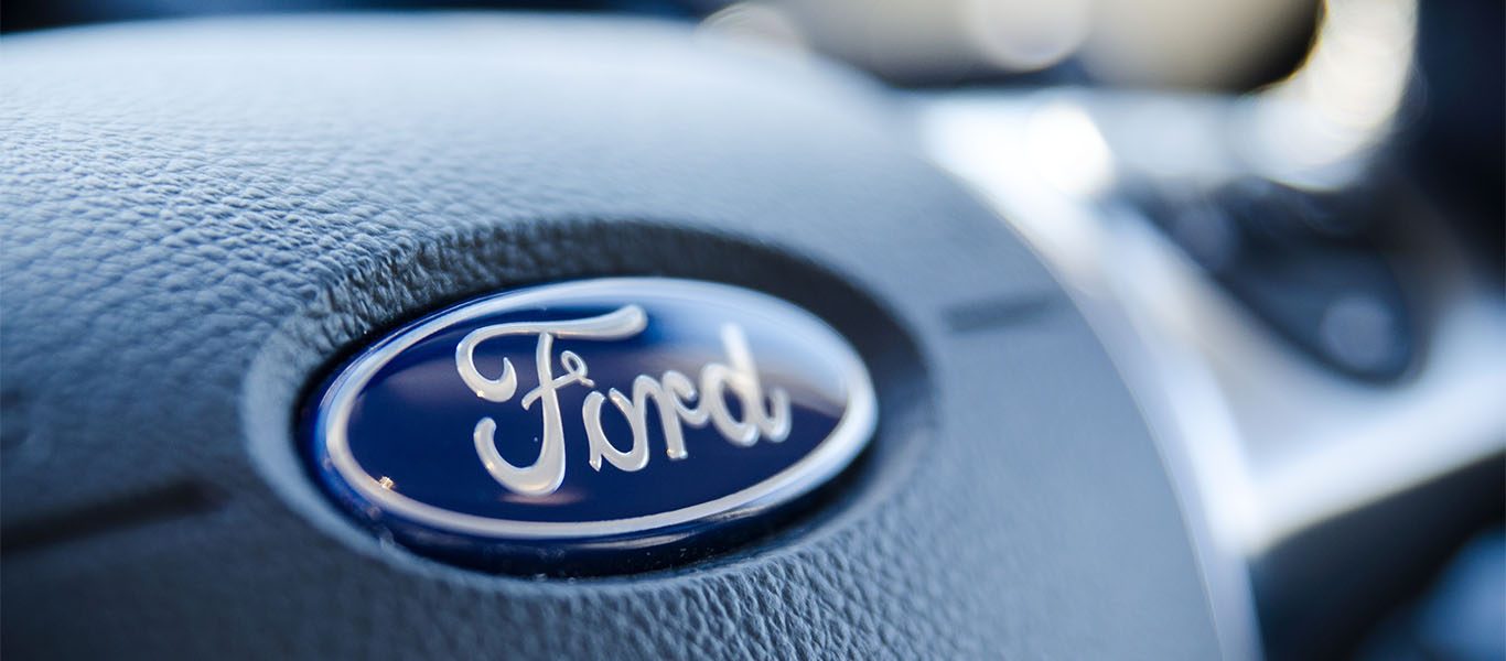 Ford logo on steering wheel in car to support recalls article