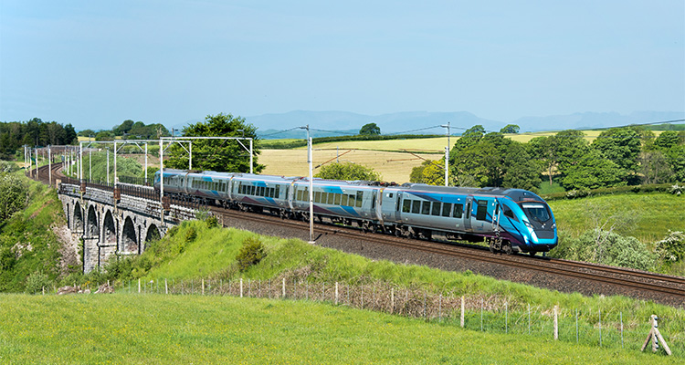 TransPennine Express is delivering on its impressive plans to provide a more reliable, punctual and dependable rail service a TransPennine Express train, traversing a viaduct in a rural setting.