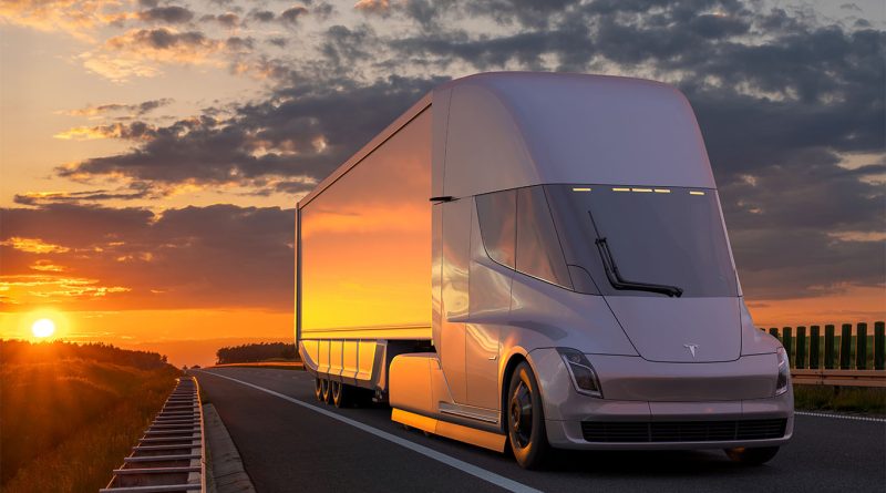 Uber Freight and Tesla launch ambitious EV truck initiative Tesla Semi trucks at a charging station with Uber Freight branding, symbolizing a logistics partnership