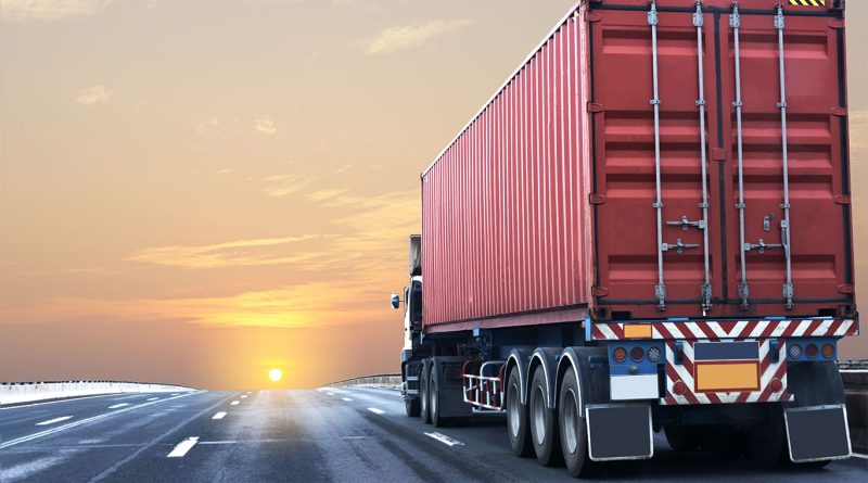 Montgomery Transport enters liquidation as market pressures mount A parked flatbed truck on an empty highway under cloudy skies, symbolizing a slowdown in the freight industry