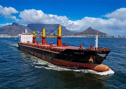 a large cargo ship, named Viellira, sailing on blue water