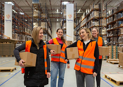 People in orange High-Vis in a warehouse