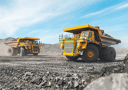heavy-duty mining dump trucks operating in a quarry or mining site