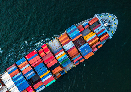 an aerial view of a container ship loaded with cargo containers