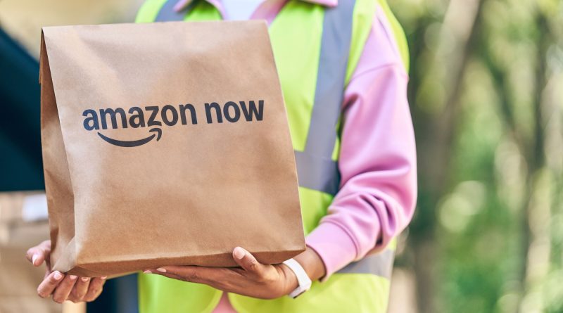 Amazon delivery driver unloading rapid grocery and household deliveries in an urban neighborhood