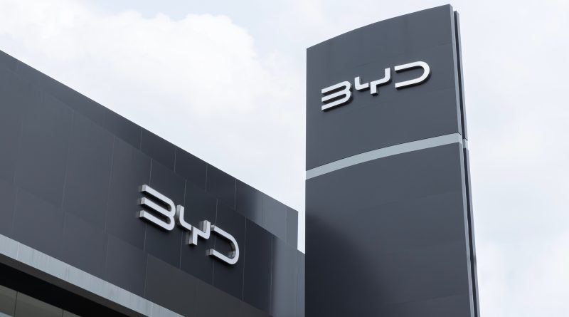 A BYD electric vehicle displayed at an international automotive exhibition, representing the Chinese automaker's global expansion ambitions and challenge to Toyota's industry leadership.