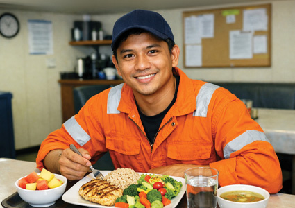 a maritime worker enjoying a healthy meal onboard a vessel.