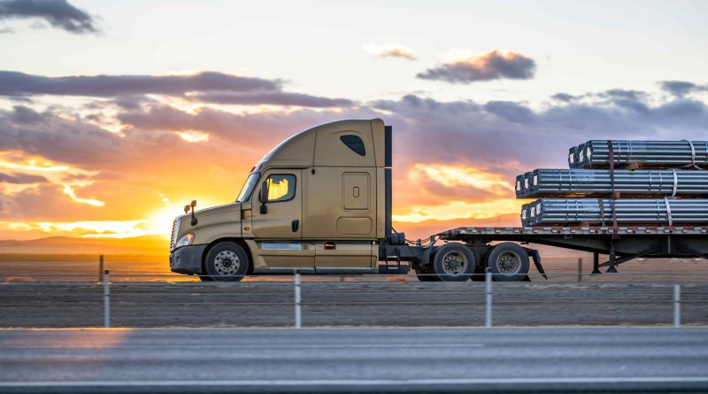 Row of semi trucks parked at a commercial truck rental and leasing yard